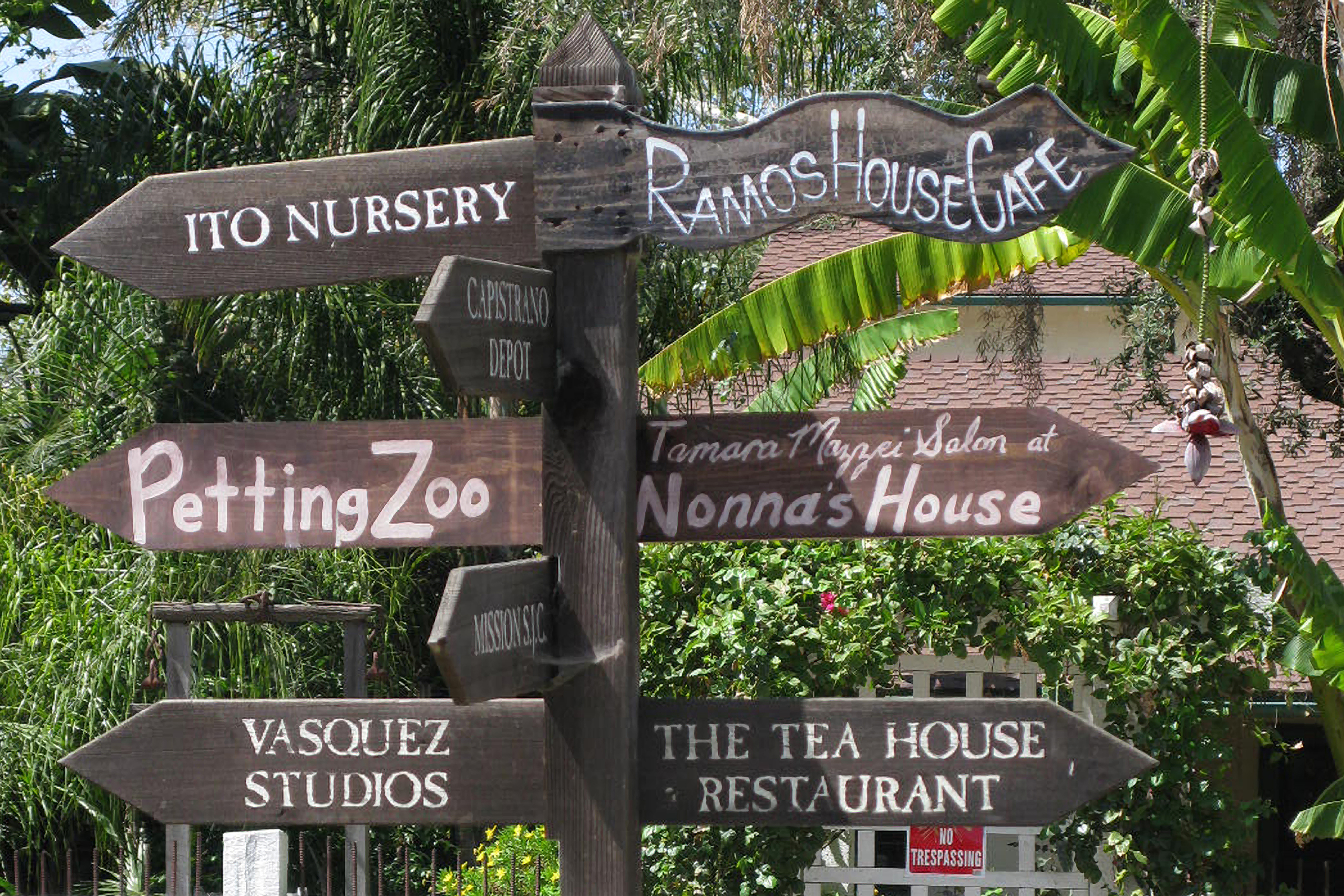 Sign in San Juan Capistrano.  Ito Nursery, Petting Zoo and Vasquez Studios to the left. Ramos House Cafe, Nonna's House, and The Tea House Restaurant to the right.